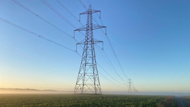 a photo of power pylons in the Cambridgeshire countryside