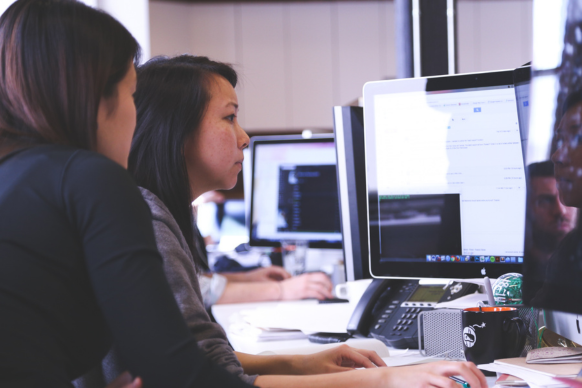 Two serious women using a computer