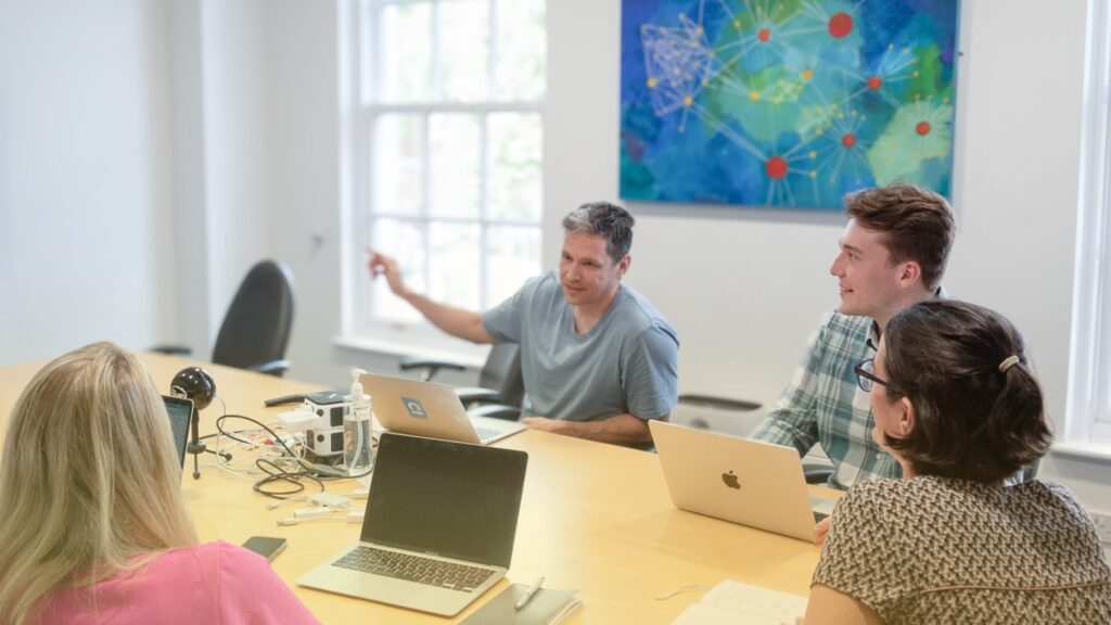 Team of colleagues from Cambridge Intelligence discussing new data visualization techniques and tools